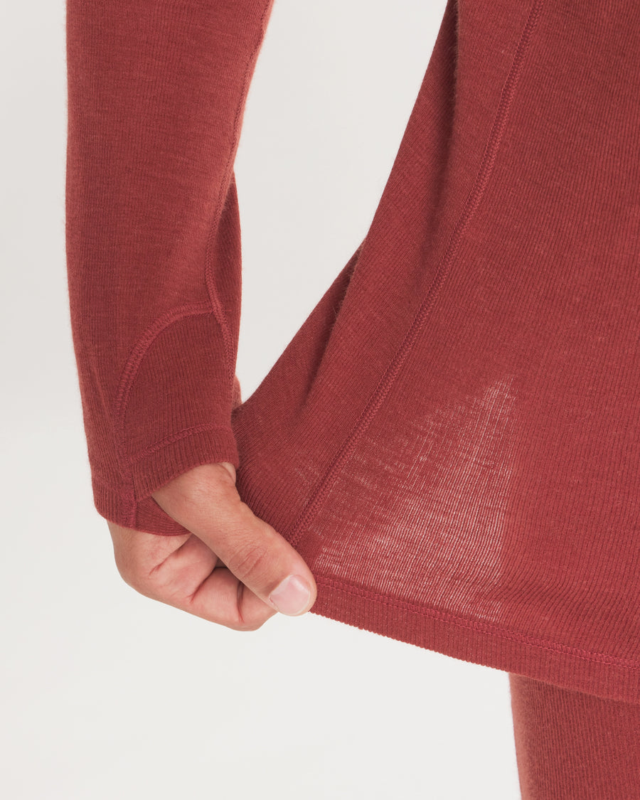 Close-up of Men’s Thermal Hoodie showcasing thumbhole, stretch 2x2 rib knit and flat coverstitch on light gray background