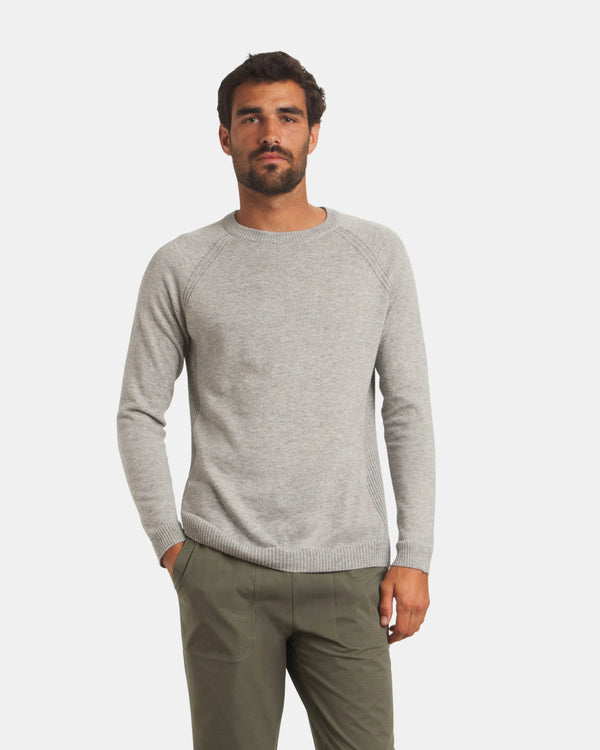 Front view of Men’s Ultralight Crew sweater in ice heather grey on model, lightweight knit with raglan sleeves and ribbed cuffs and hem