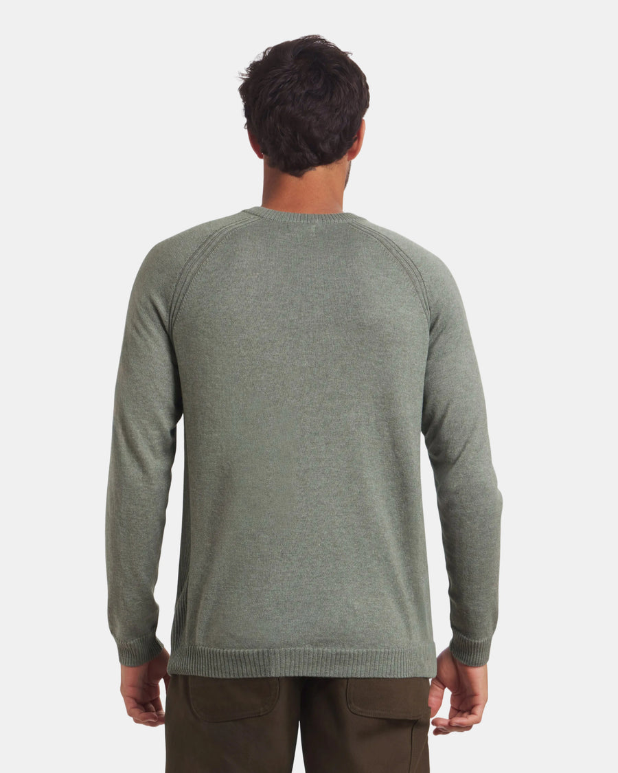 Back view of Men’s Ultralight Crew in lichen on model showing raglan sleeves and ribbed cuffs against light gray background