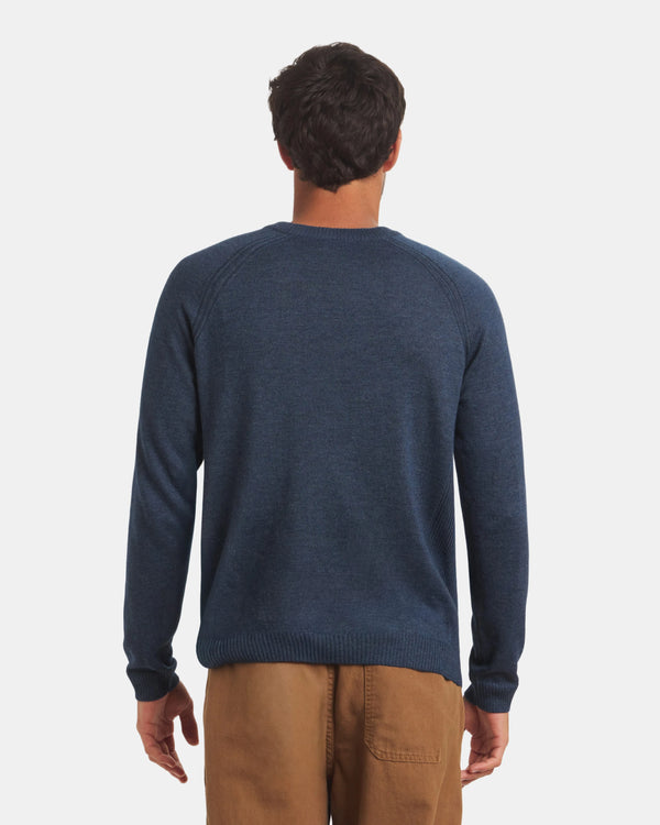 Back view of Men’s Ultralight Crew in navy on model showing raglan sleeve seams and ribbed hem against a light gray background