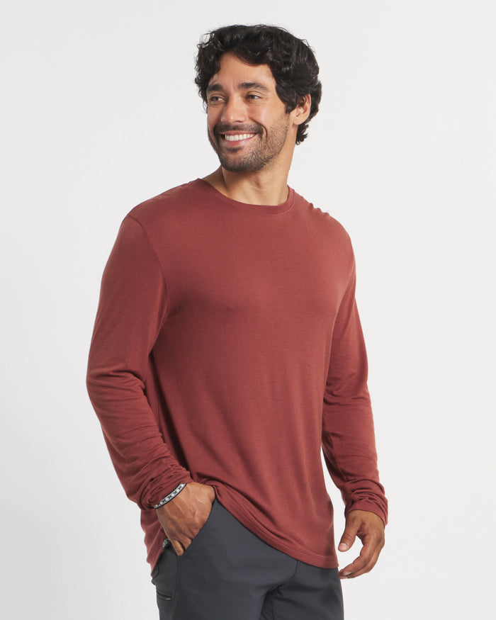 Three-quarter view of Men’s Aire long sleeve alpaca shirt in clay red on model, lightweight regular fit