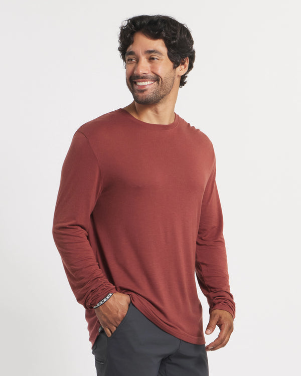 Three-quarter view of Men’s Aire long sleeve alpaca shirt in clay red on model, lightweight regular fit