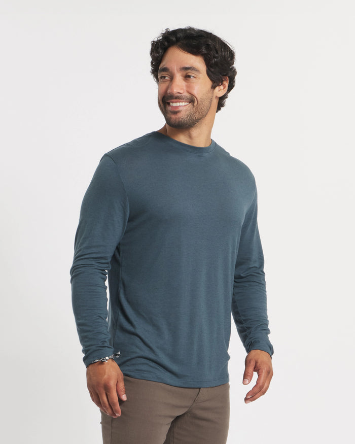 Three-quarter view of Men’s Aire long sleeve alpaca shirt in navy showing lightweight, breathable fabric and fitted look on a model with white background
