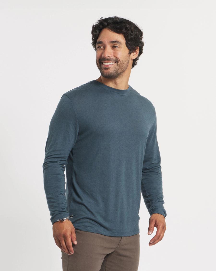Three-quarter view of Men’s Aire long sleeve alpaca shirt in navy showing lightweight, breathable fabric and fitted look on a model with white background
