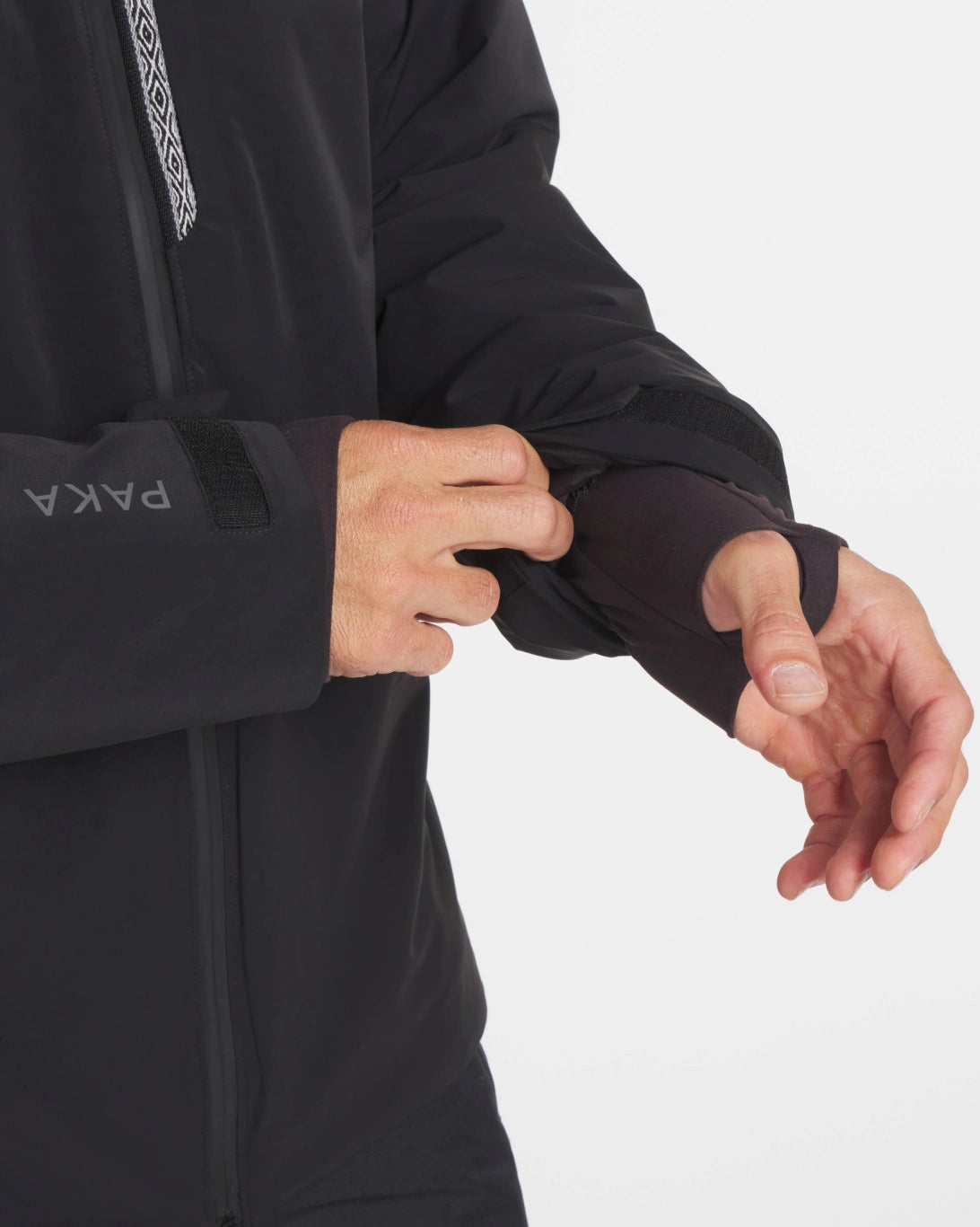Hands Through Thumbholes of Apu Men's Black Waterproof Parka Winter Ski Jacket with Natural PAKAFILL® Insulation – PAKA Apparel