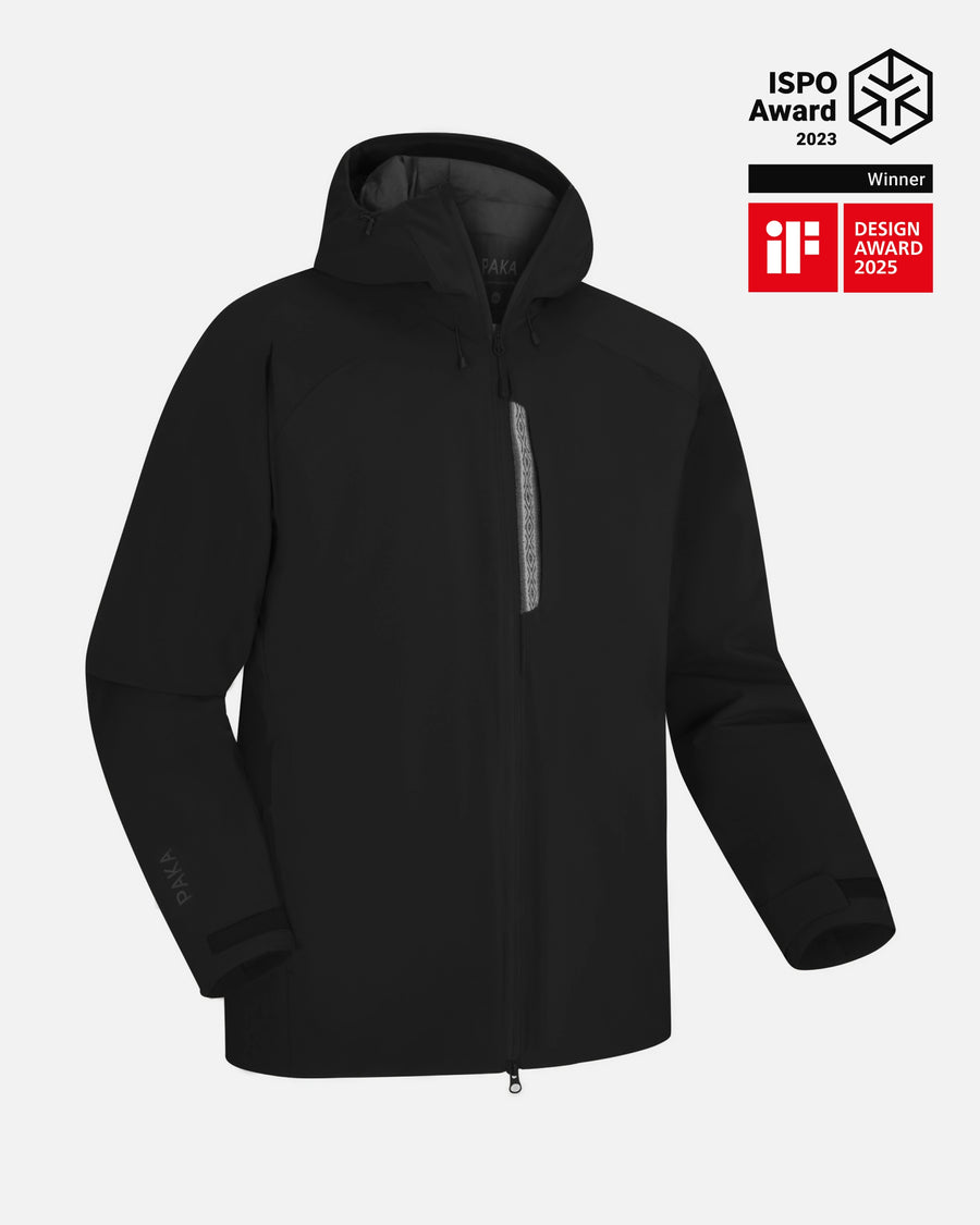 Front view of Men’s Apu Parka in black with hood, chest zip, adjustable cuffs, and PAKA logo on sleeve on pale gray