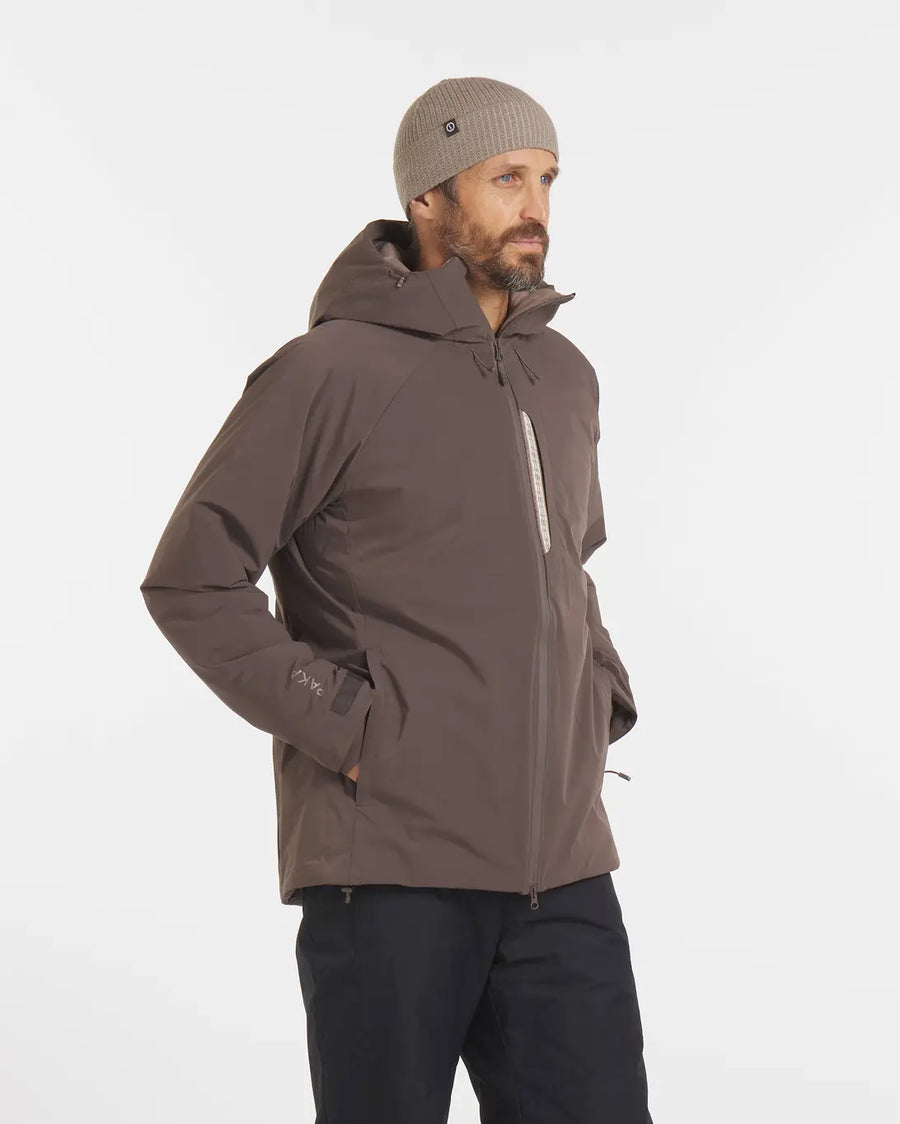 Model Looking Sideward in Apu Wood Brown Men's Parka Ethical Winter Ski Jacket with Natural Fiber Insulation – PAKA Apparel
