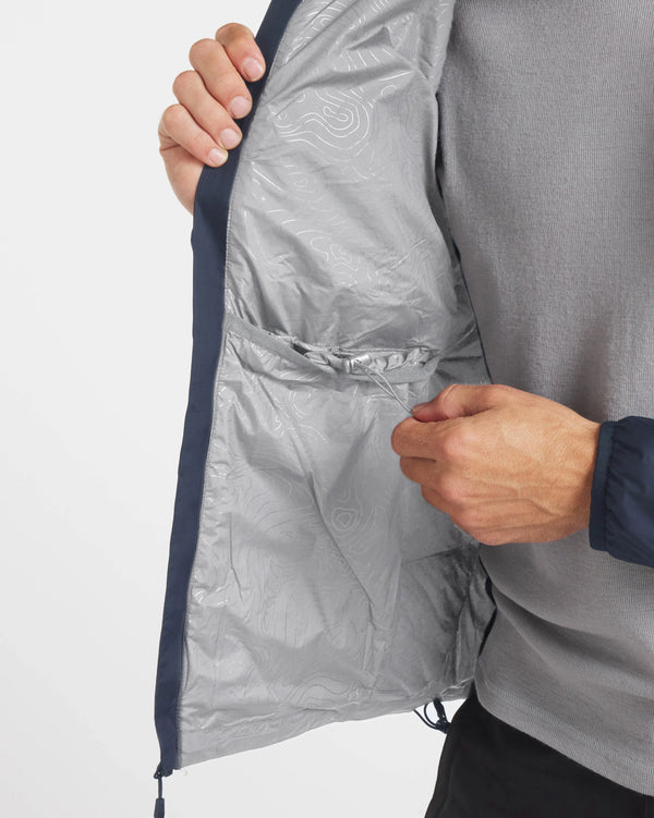 Inside view of Men’s Apu Lightweight Puffer jacket showing interior pocket, adjustable hem drawcord, and patterned lining