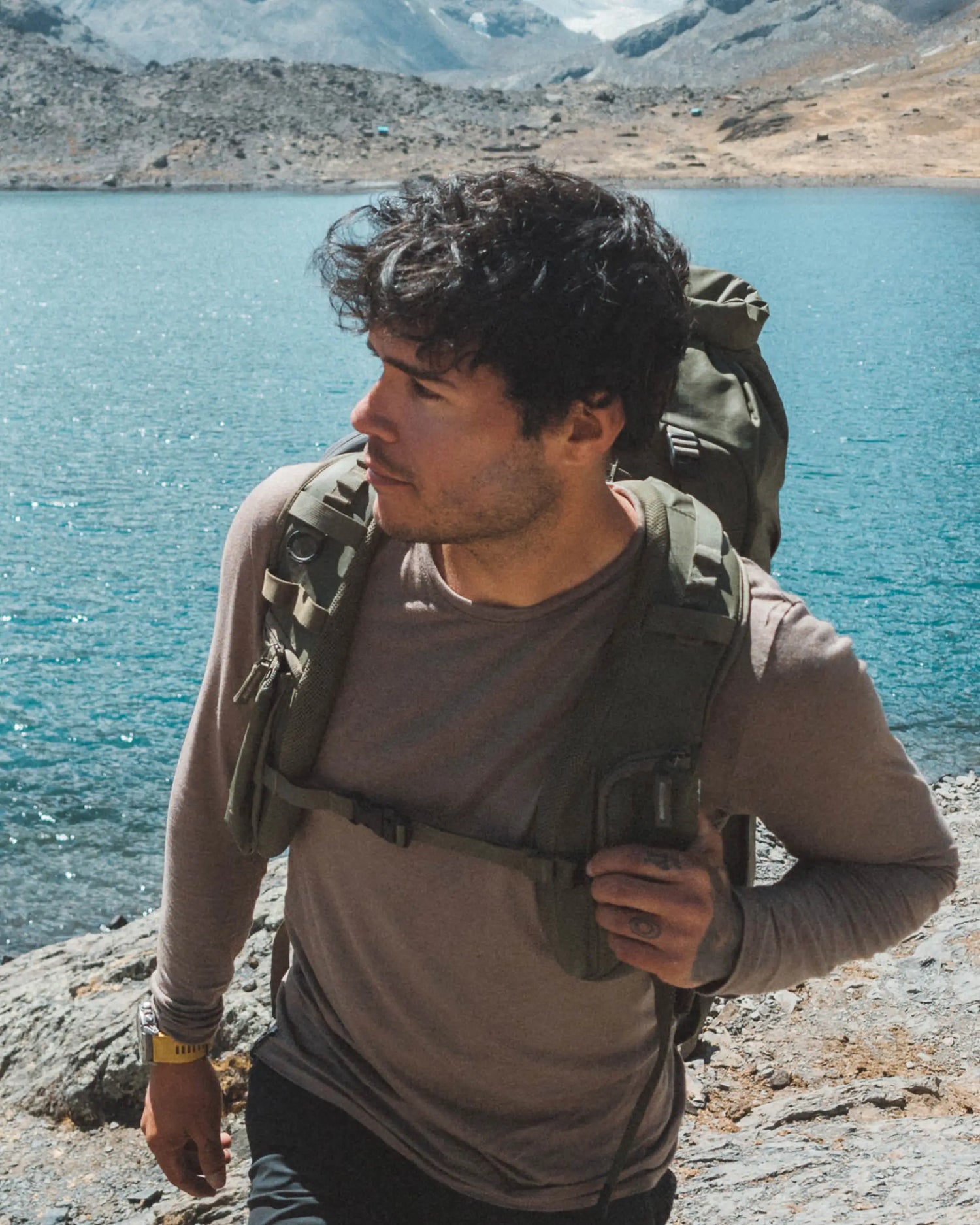 Man Named Jose Wearing Aire Long Sleeve Shirt in Walnut / Tan and Backpack by Mountain Lake – PAKA Apparel