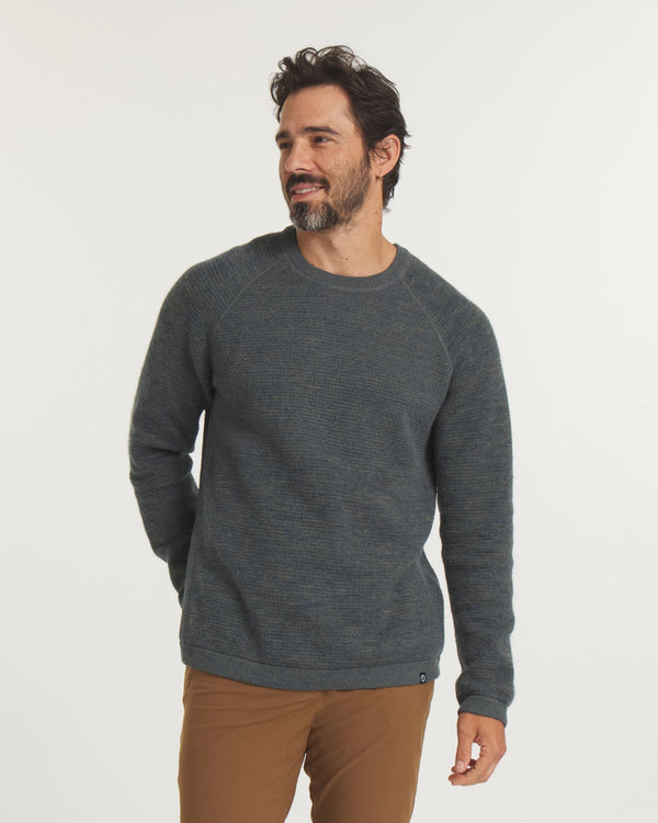 Three-quarter front view of Men’s Mountain Crew sweater showcasing raglan sleeves and textured two-tone forest blue-green knit on white background