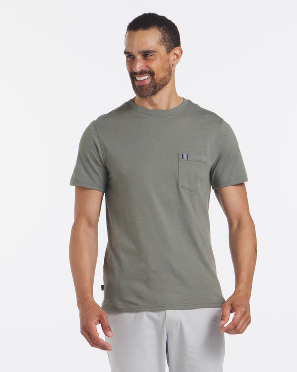Three-quarter view of men’s alpaca-blend pocket tee in olive green showing chest pocket, crew neck, short sleeves, and regular fit on model against white background