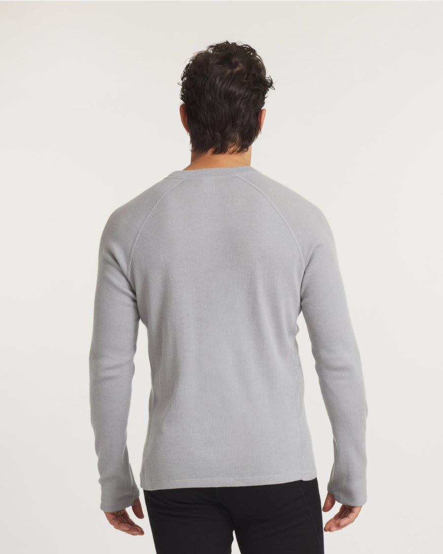 Rear view of Men’s Thermal Crew alpaca baselayer showing raglan sleeves and slim fit on model with off-white background