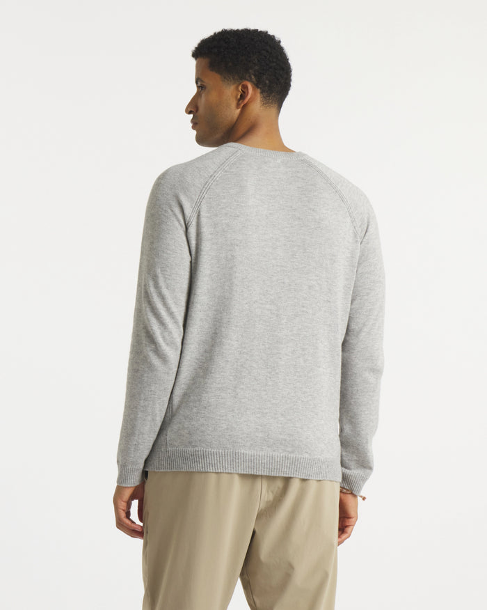 Back view of Men’s Ultralight 1.0 Crew alpaca sweater showing raglan sleeve seams and ribbed hem on white background