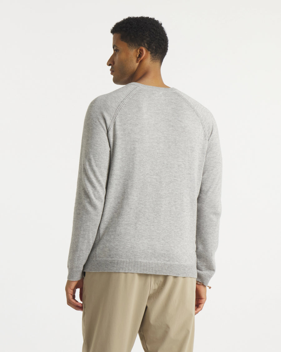 Back view of Men’s Ultralight 1.0 Crew alpaca sweater showing raglan sleeve seams and ribbed hem on white background