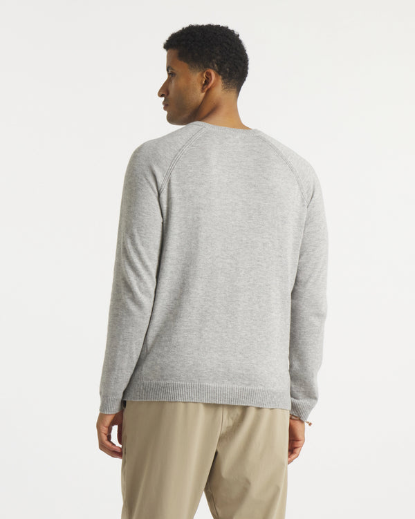 Back view of Men’s Ultralight 1.0 Crew alpaca sweater showing raglan sleeve seams and ribbed hem on white background