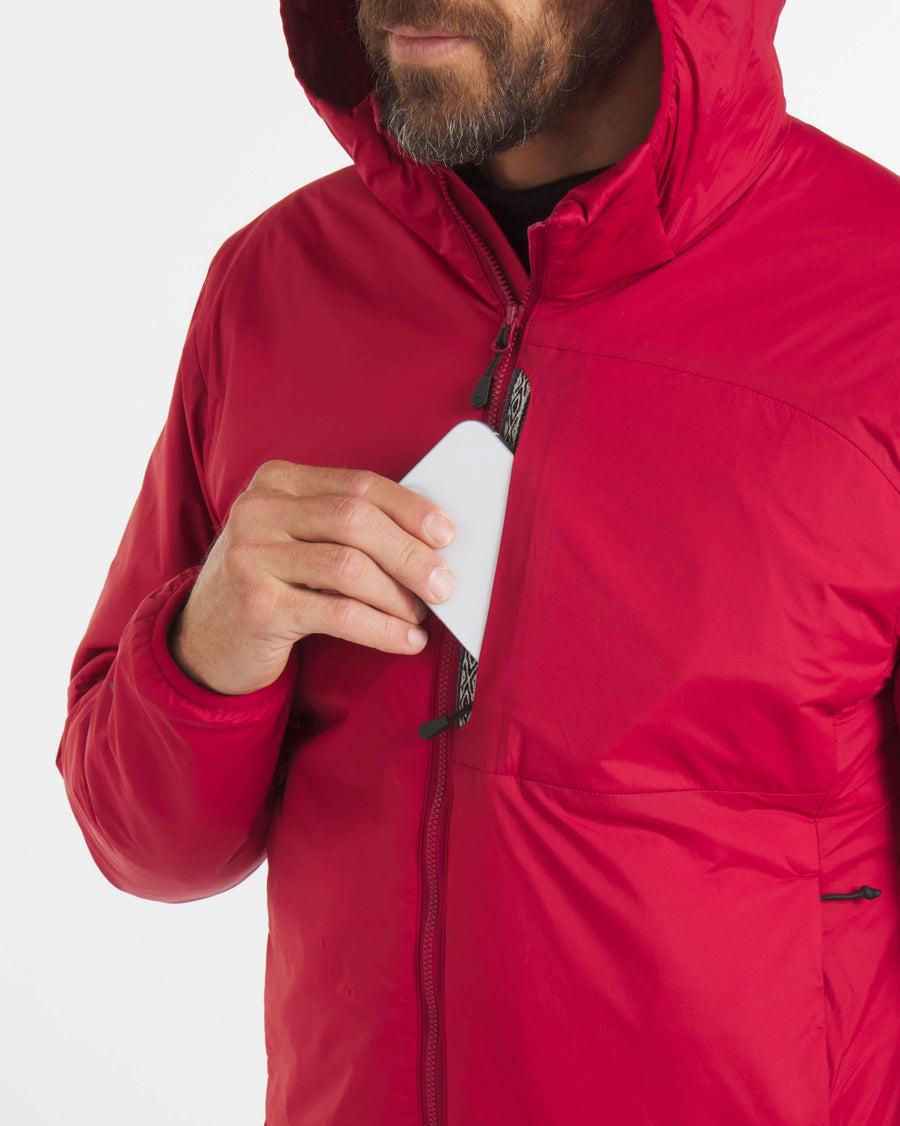 Man Placing Phone in Chest Pocket of Men's Apu Lightweight Puffer Jacket in Maca Red – PAKA Apparel