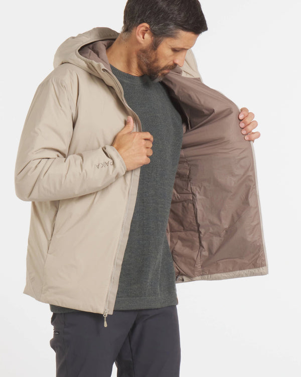 Three-quarter view of Men’s Apu Lightweight Puffer jacket in desert, unzipped to show interior lining, worn by model