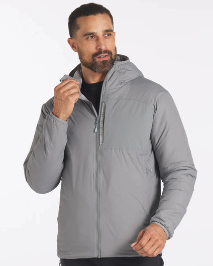 Three-quarter front of Men’s Apu Lightweight Puffer in storm gray showing hood, chest zip pocket, and front zipper on white background