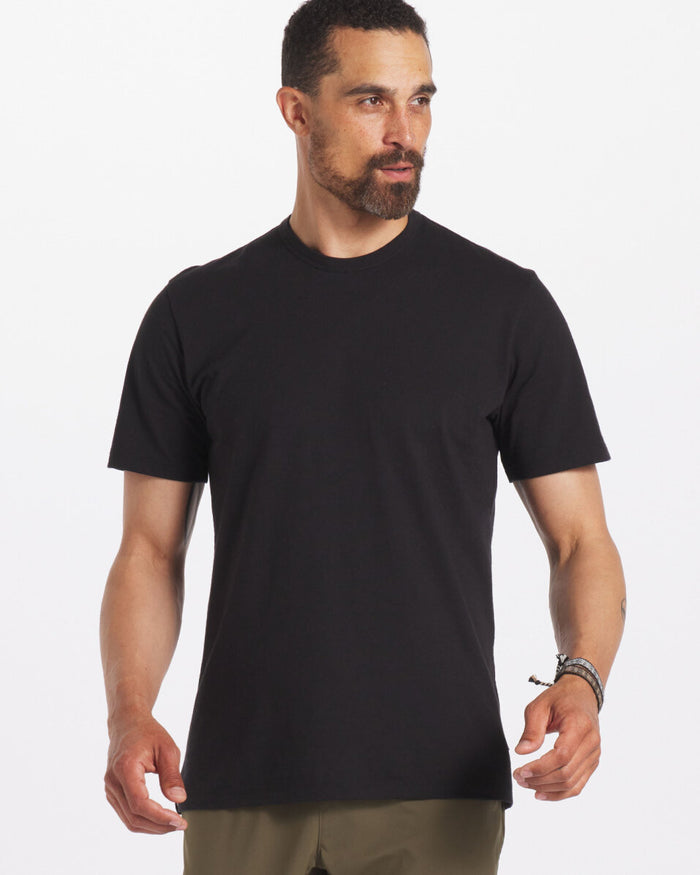 Model is 6'3" and wearing size Large. Man Wearing Sustainable Black T-Shirt in Organic Pima Cotton and Alpaca Blend – PAKA Apparel