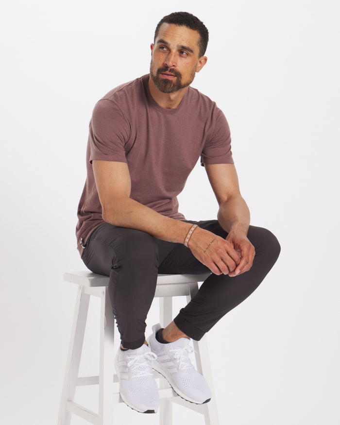 Man Sitting on Chair Looking to the Left in Mauve Organic Pima Cotton and Alpaca Blend T-Shirt – PAKA Apparel