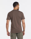 Back view of Men’s Tee in Wood on male model showing short sleeves and regular fit against a white background