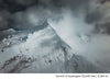 Snow-covered mountain summit rising through clouds in the Andes near Ausangate