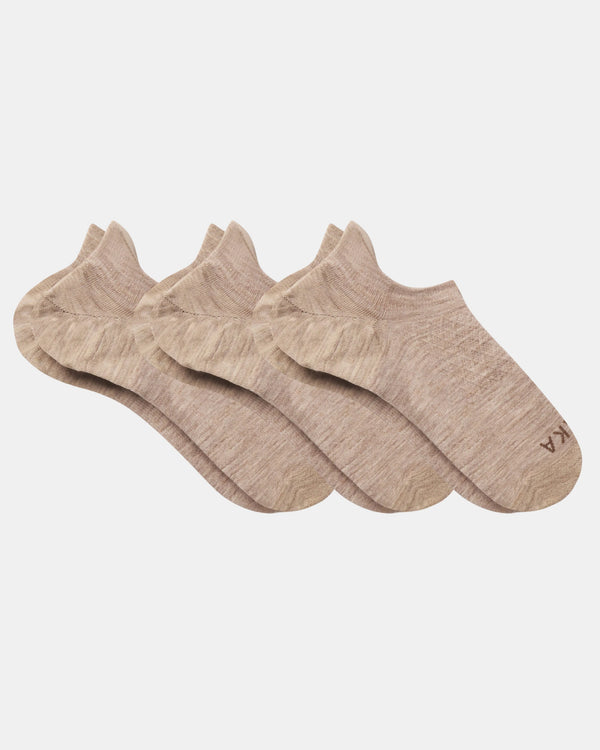 Top view of three beige Essential No Show Socks laid flat showcasing low-cut no-show design and marled knit on light gray background