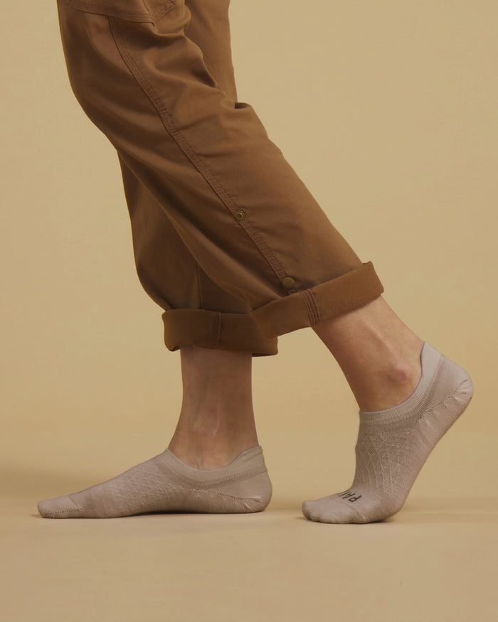 Side view of Timber alpaca no-show socks on a model showcasing low-profile no-show fit and textured knit against a beige background