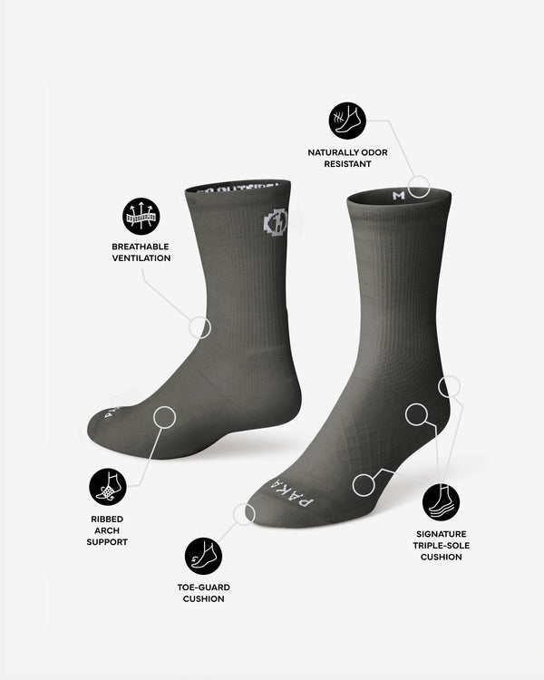 Angled front of Trail 3/4 Crew socks in charcoal showing breathable vents, triple-sole cushion, and odor resistant