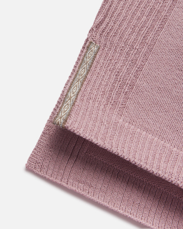 Close-up of women’s alpaca hoodie hem showcasing ribbed knit texture and woven PAKA tag on a white background