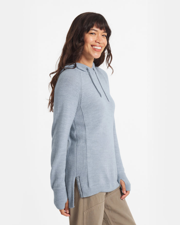 Three-quarter view of women’s light blue alpaca hoodie with ribbed sides, thumbhole cuffs, relaxed fit on white background
