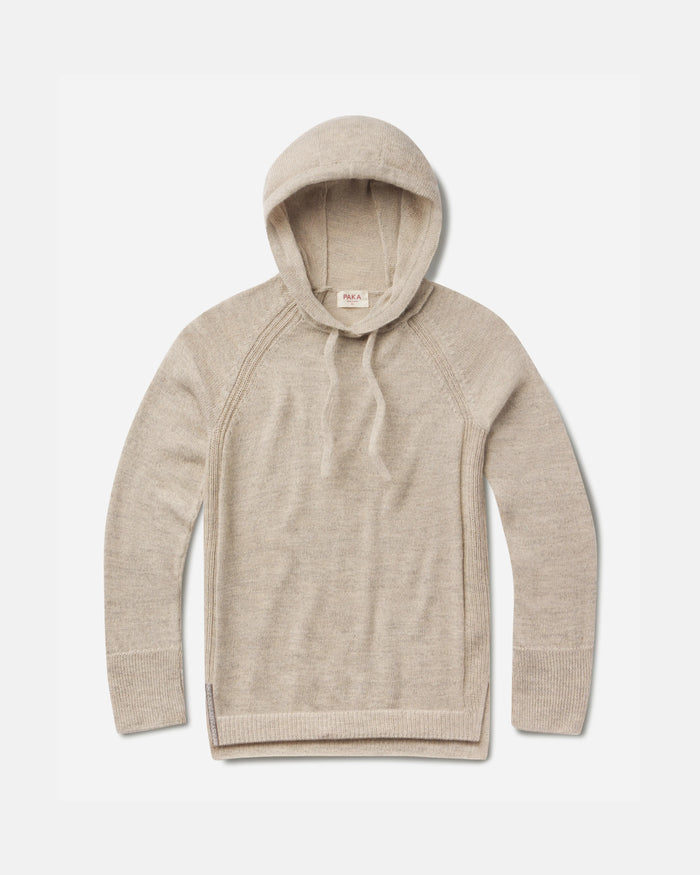 Flat lay of women’s alpaca hoodie showing lightweight knit, raglan sleeves, drawstring hood, and ribbed cuffs on white background