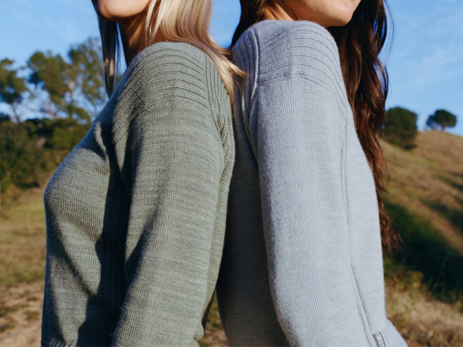 Side view of Women’s Original Crew alpaca sweater showing ribbed shoulder detail and relaxed fit on models outdoors