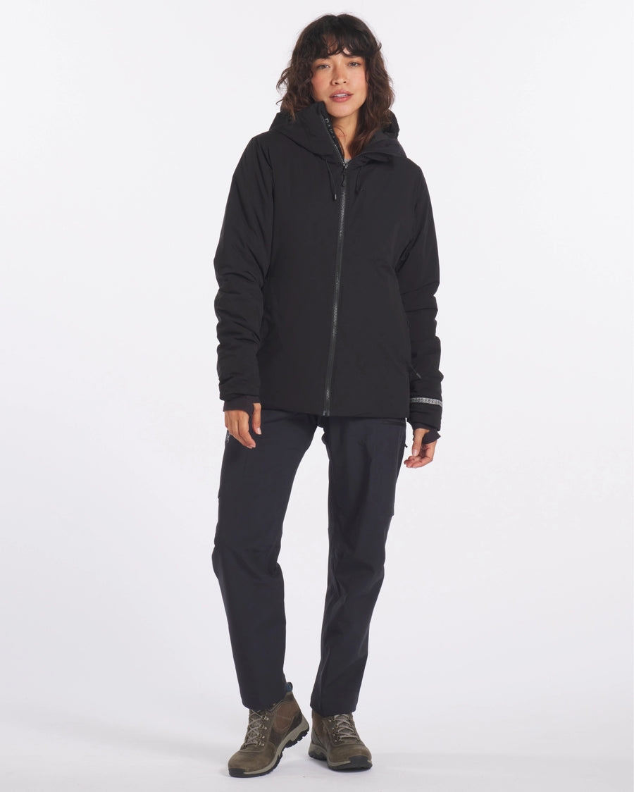 Front view of The Original Women’s Apu Parka on a model showing hooded, hip-length insulated silhouette with center zip on white background