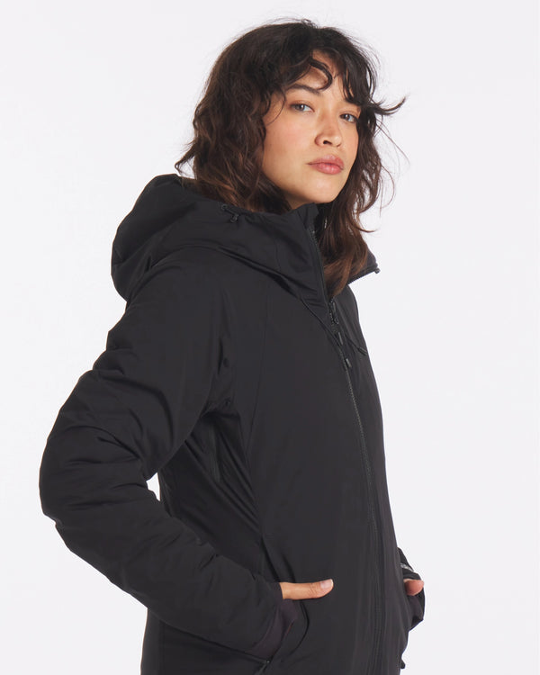Three-quarter side view of The Original Women’s Apu Parka showcasing insulated hood, full-length zipper, and hand pockets on white background
