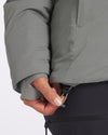 Close-up of Apu Parka hem showcasing adjustable drawcord and cord lock with model wearing dark pants in background