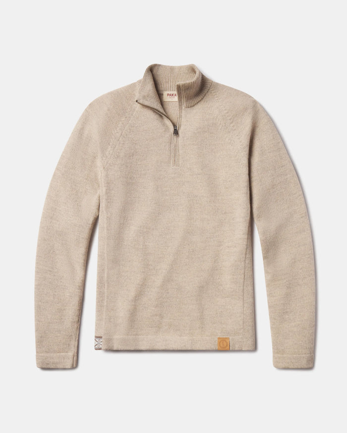 Flat lay of The Quarter Zip alpaca sweater showing quarter-zip collar, raglan sleeves, and leather logo patch on white background