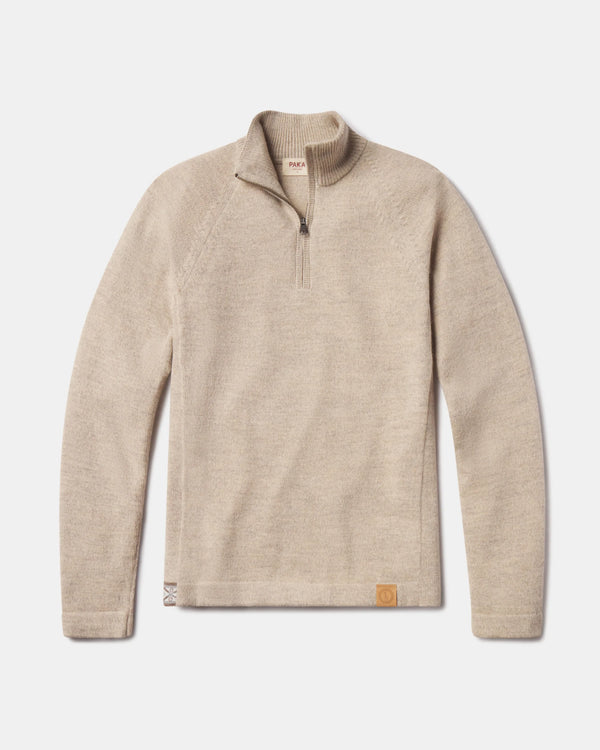 Flat lay of The Quarter Zip alpaca sweater showing quarter-zip collar, raglan sleeves, and leather logo patch on white background
