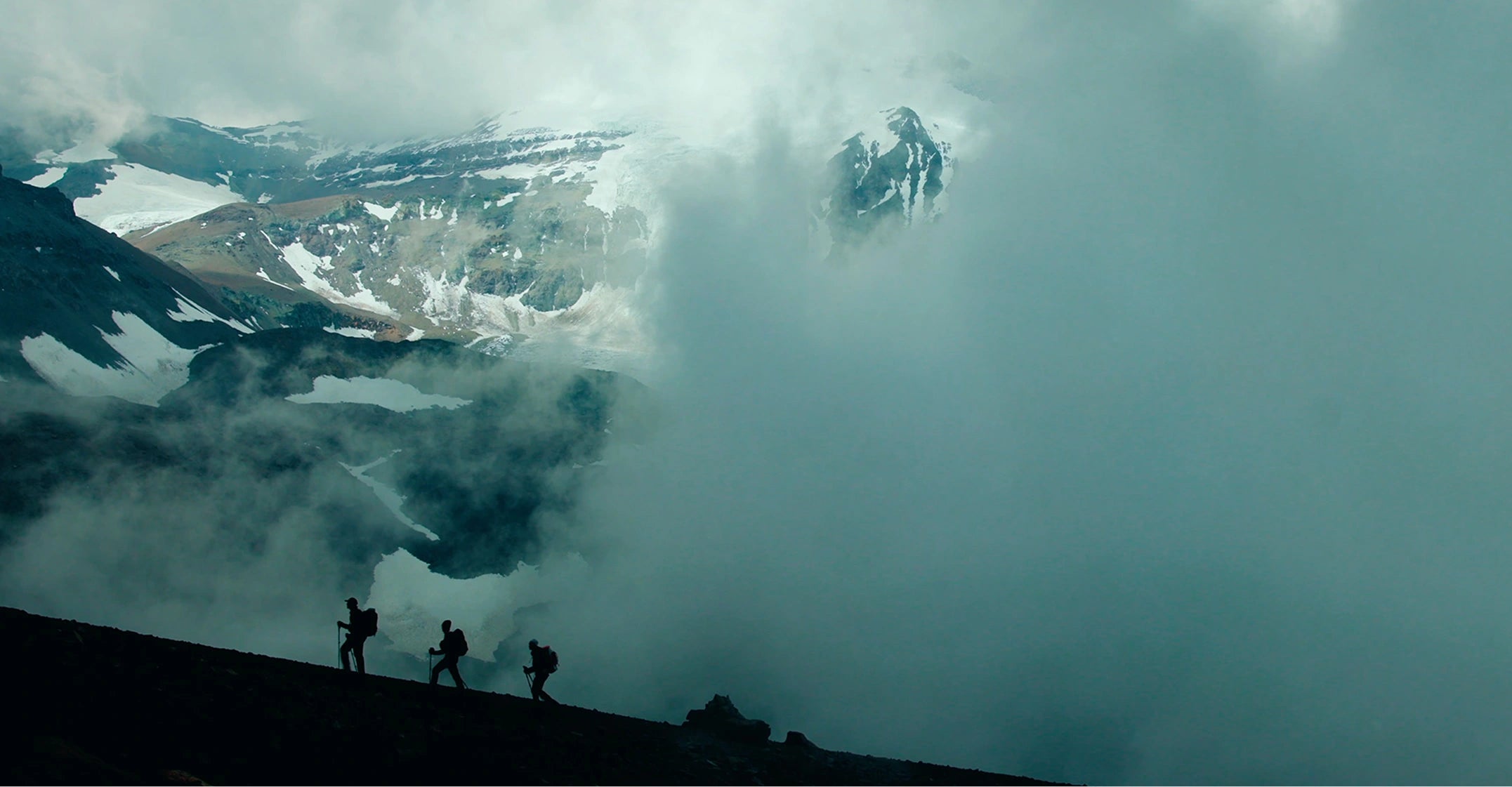 Climbers traversing a foggy Andean ridge near Cerro Marmolejo in Chile