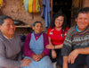 Group of Peruvian young women scholars smiling and sitting together in a home during PAKA scholarship visit