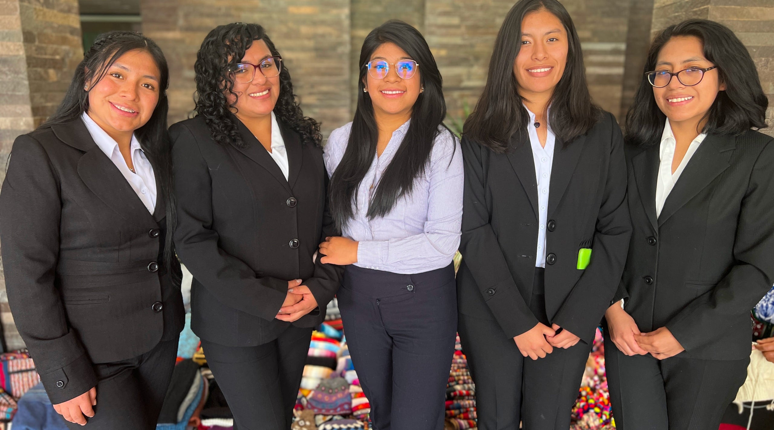Peruvian scholarship recipients smiling together outdoors during a PAKA visit