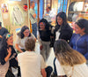 Peruvian scholarship recipients and PAKA team meeting around a table during a site visit in Peru