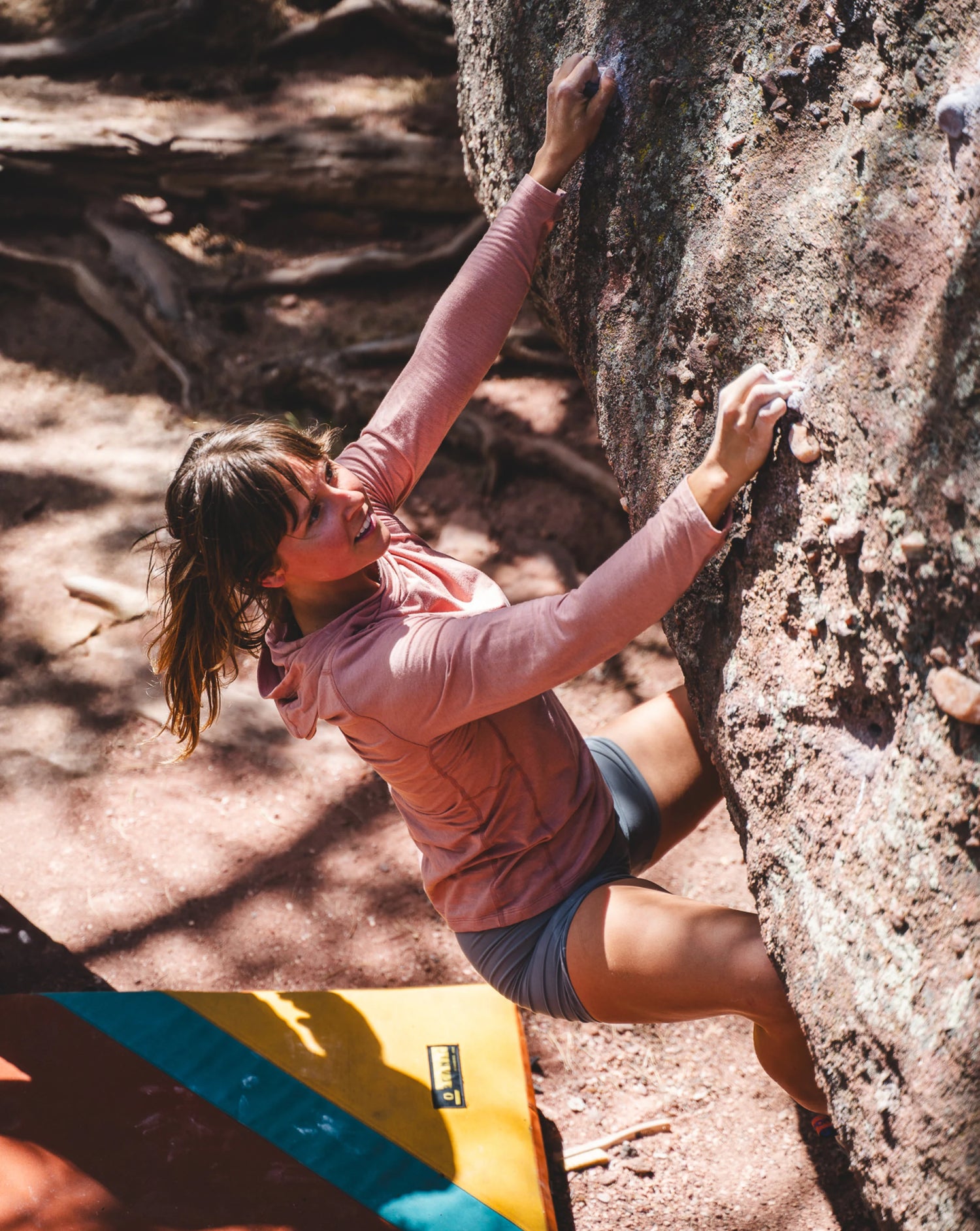 Woman Named Rachael Rock Climbing in Sol Sun Hoodie in Guava / Pink – PAKA Apparel
