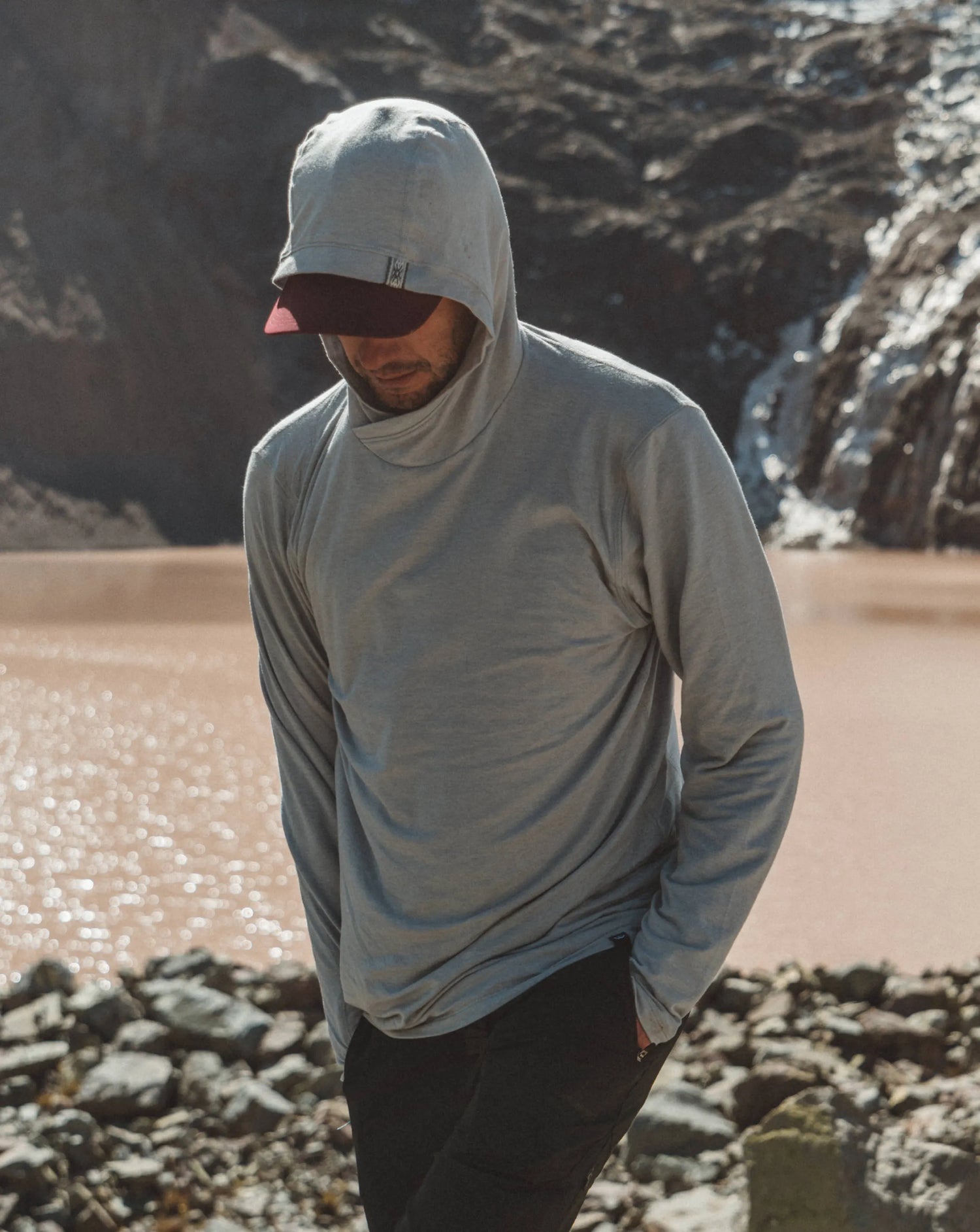 Man Named Louis in Front of Mountain Lake in Heather Grey Sol Men’s Lightweight Sun Hoodie – PAKA Apparel