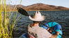 A man sailing on a river wearing one of our alpaca shirts