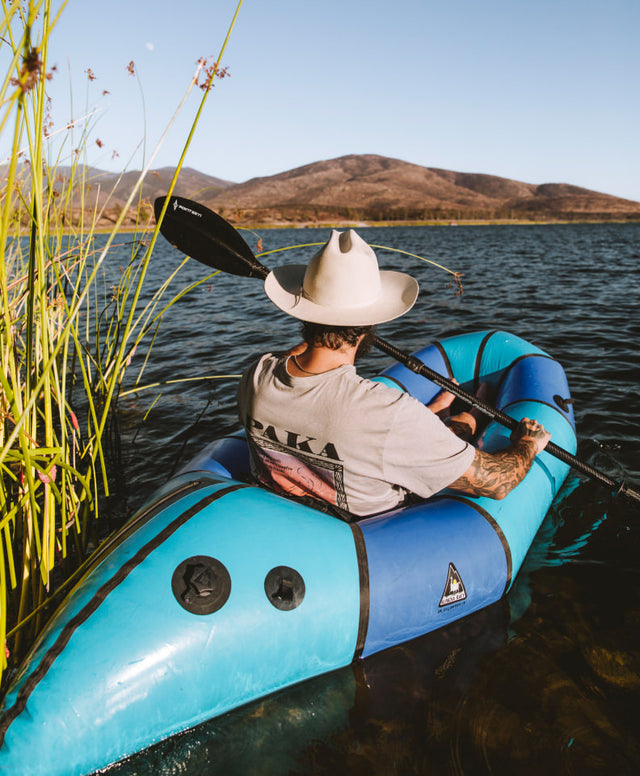 A man sailing on a river wearing one of our alpaca shirts