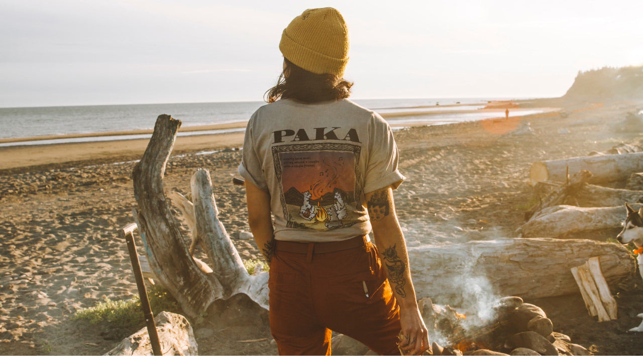 A tattooed girl wearing an alpaca shirt that says 