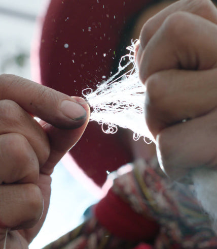 A Quechua woman counting alpaca fibers