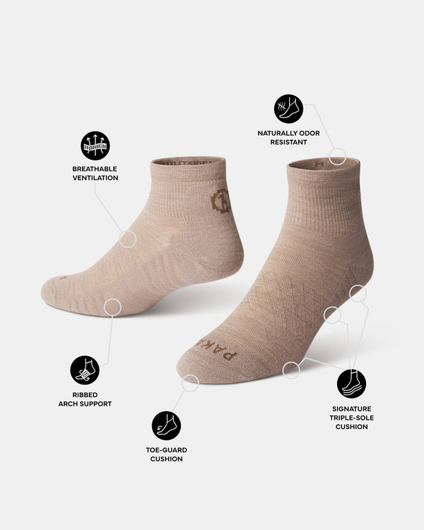 Angled view of Trail 1/4 Crew socks in tan showing breathable ventilation, ribbed arch support, toe-guard and triple-sole cushioning on white background