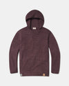 Front view of The Hoodie alpaca wool pullover with hood in raisin, showing knit texture and front hem logo on white background